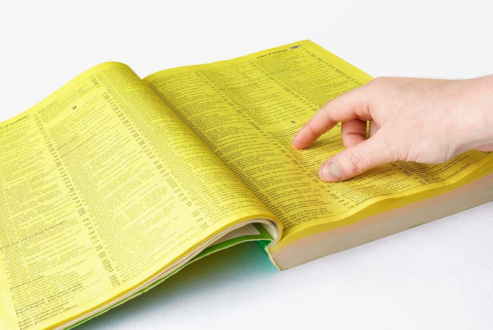 Human hand and yellow pages